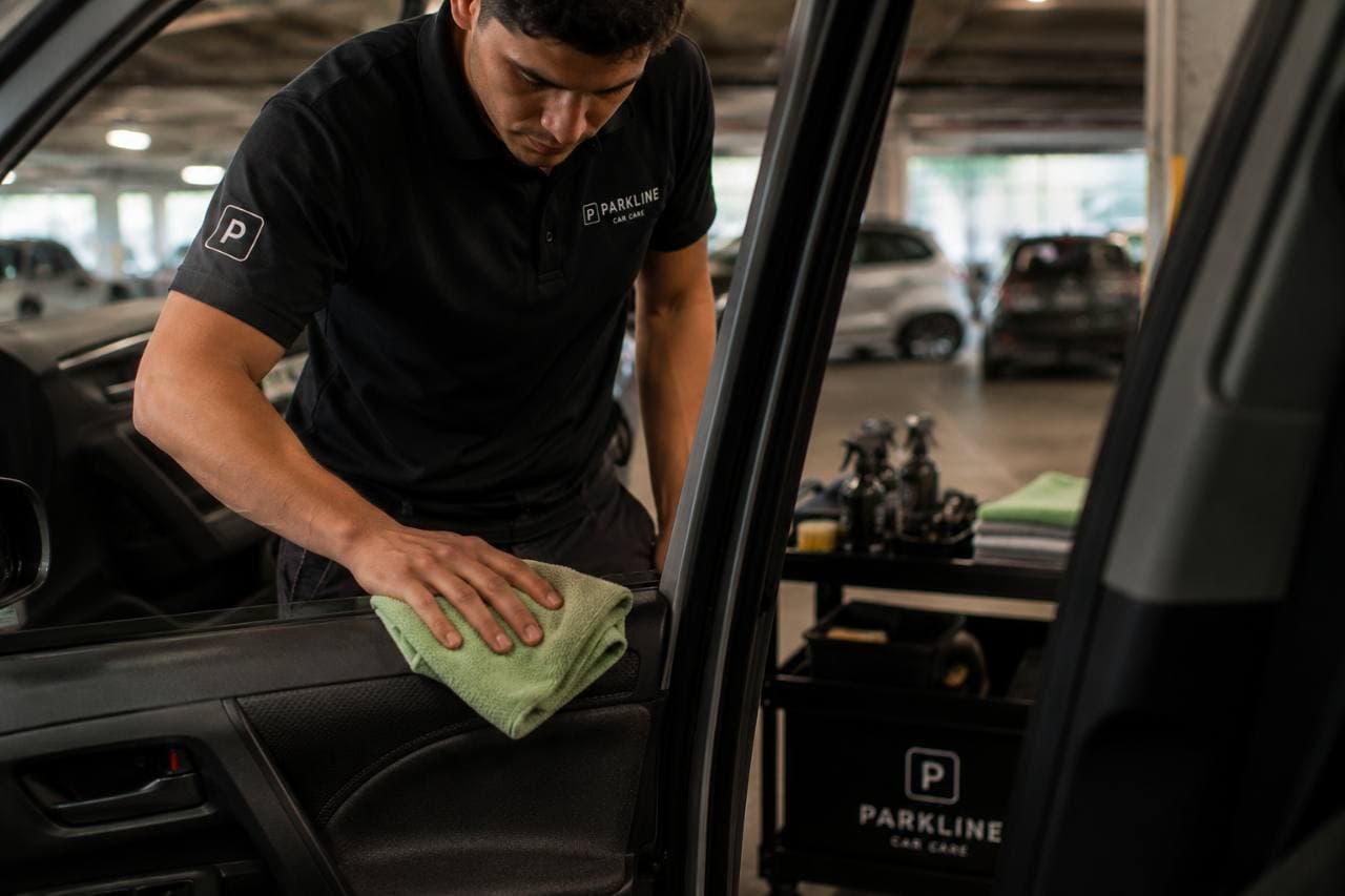 Parkline technician carefully cleaning a vehicle interior
